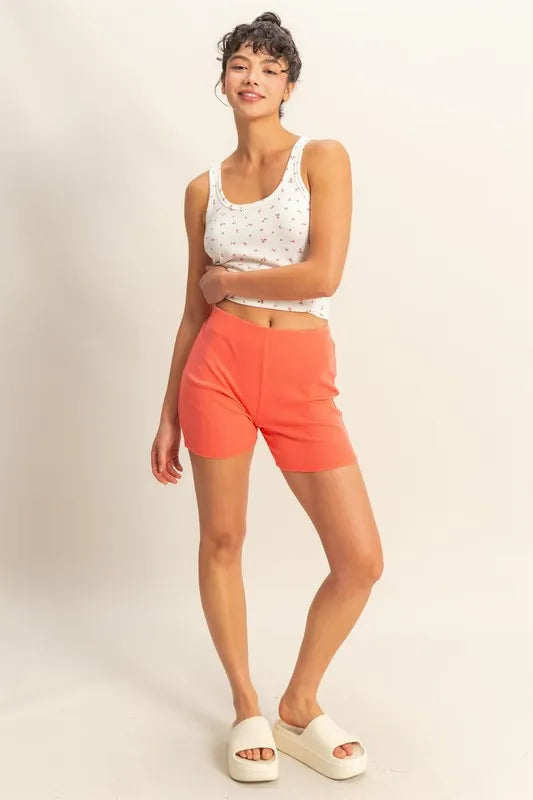 Coral high waist ribbed fitted biker shorts by HYFVE, shown on a model, featuring a comfortable, stretchy ribbed fabric design.