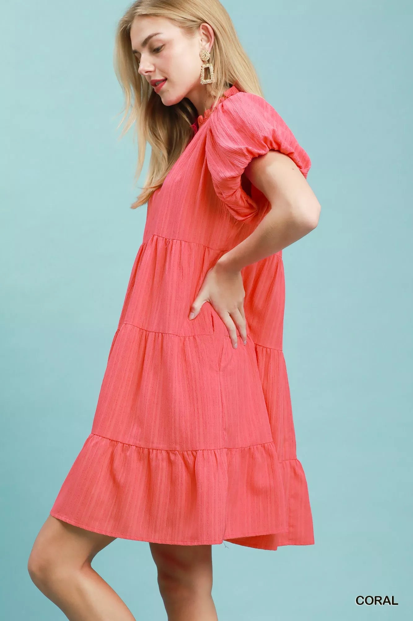 Coral Umgee puff sleeve tiered babydoll dress with ruffled sleeves and flowing silhouette, styled for casual or summer wear.
