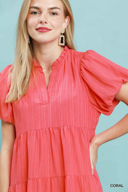 Coral Umgee puff sleeve tiered babydoll dress with ruffled details and flowy silhouette, perfect for casual or summer wear.