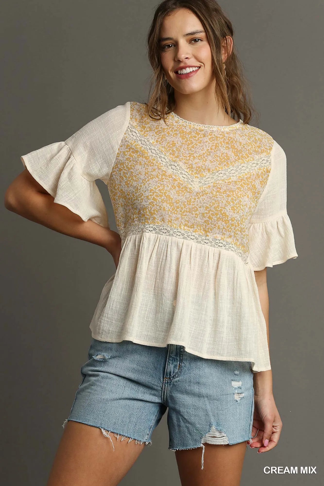 Cream floral lace-trimmed half sleeve babydoll top by Umgee, featuring a relaxed fit and delicate lace details.