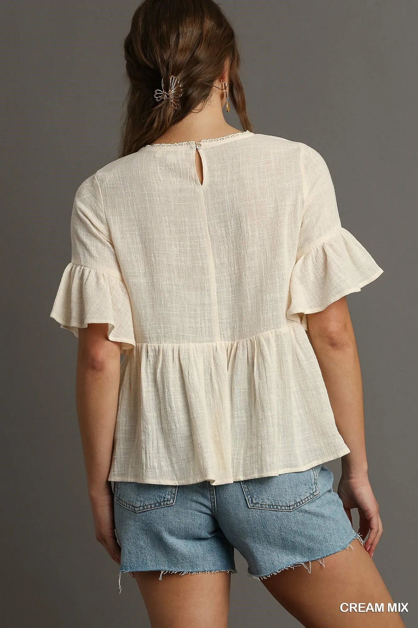 Cream floral lace trimmed half sleeve babydoll top by Umgee, featuring a relaxed fit and delicate lace details.