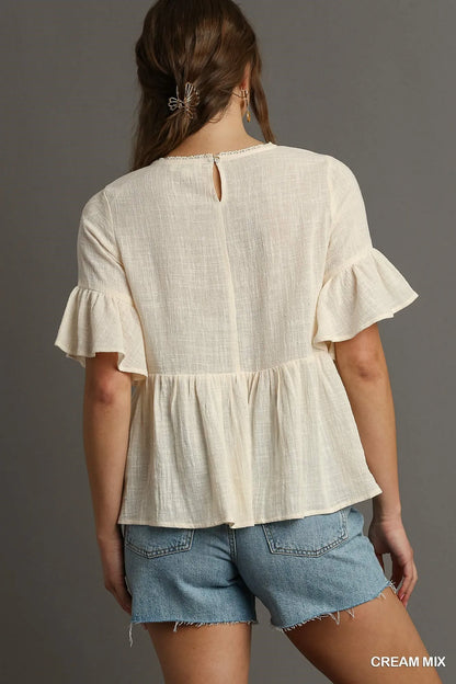 Cream floral lace trimmed half sleeve babydoll top by Umgee, featuring a relaxed fit and delicate lace details.