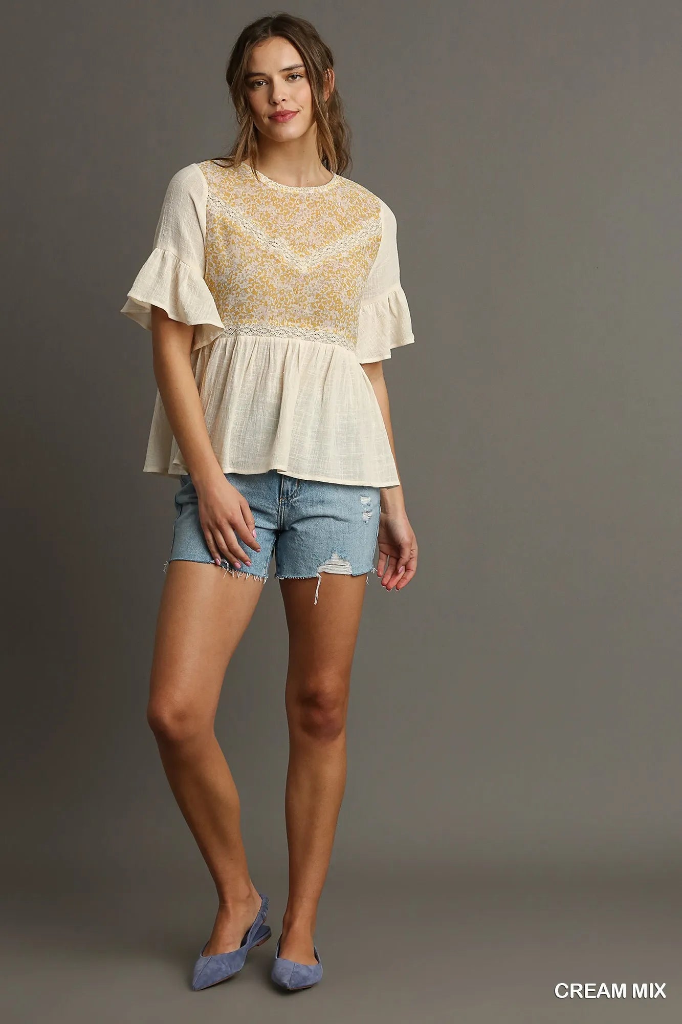 Cream floral lace trimmed half sleeve babydoll top by Umgee, featuring a feminine design and relaxed fit.