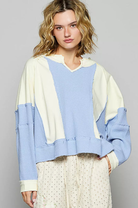 Cream and multi-color block waffle knit sweatshirt with raw hem from Trendsi, showcasing a cozy, casual style.
