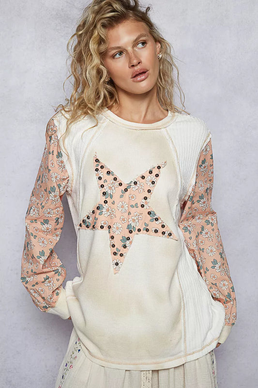 Cream thermal top with floral sleeves and exposed star patch seams by Trendsi, stylish and cozy for casual wear.