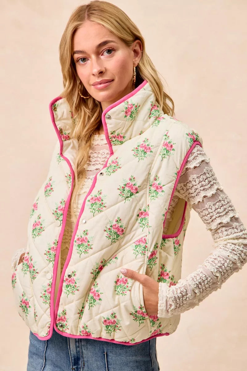 Cream and pink floral print quilted vest with piping detail from Trendsi, featuring a stylish and cozy design.