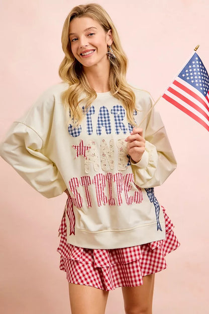 Cream sweatshirt by Trendsi featuring 4th of July stars and stripes patches, patriotic design, casual style, and comfortable fit.