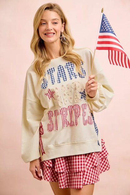 Cream sweatshirt with red, white, and blue stars and stripes patches, featuring the BiBi 4th of July design by Trendsi.