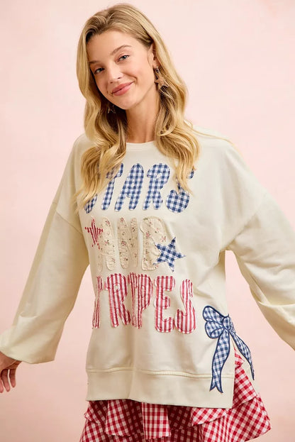 Cream sweatshirt with 4th of July stars and stripes patches from BiBi by Trendsi, featuring patriotic flag designs and casual comfort.