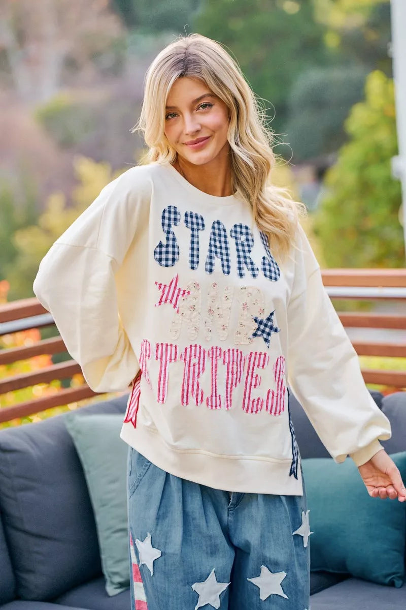 Cream BiBi 4th of July stars and stripes patches sweatshirt with patriotic design, featuring red, white, and blue accents.