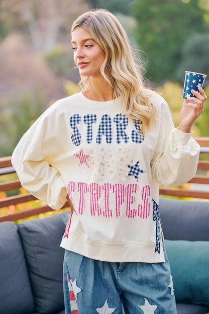 Cream sweatshirt with 4th of July stars and stripes patches from BiBi by Trendsi, featuring patriotic American flag designs.