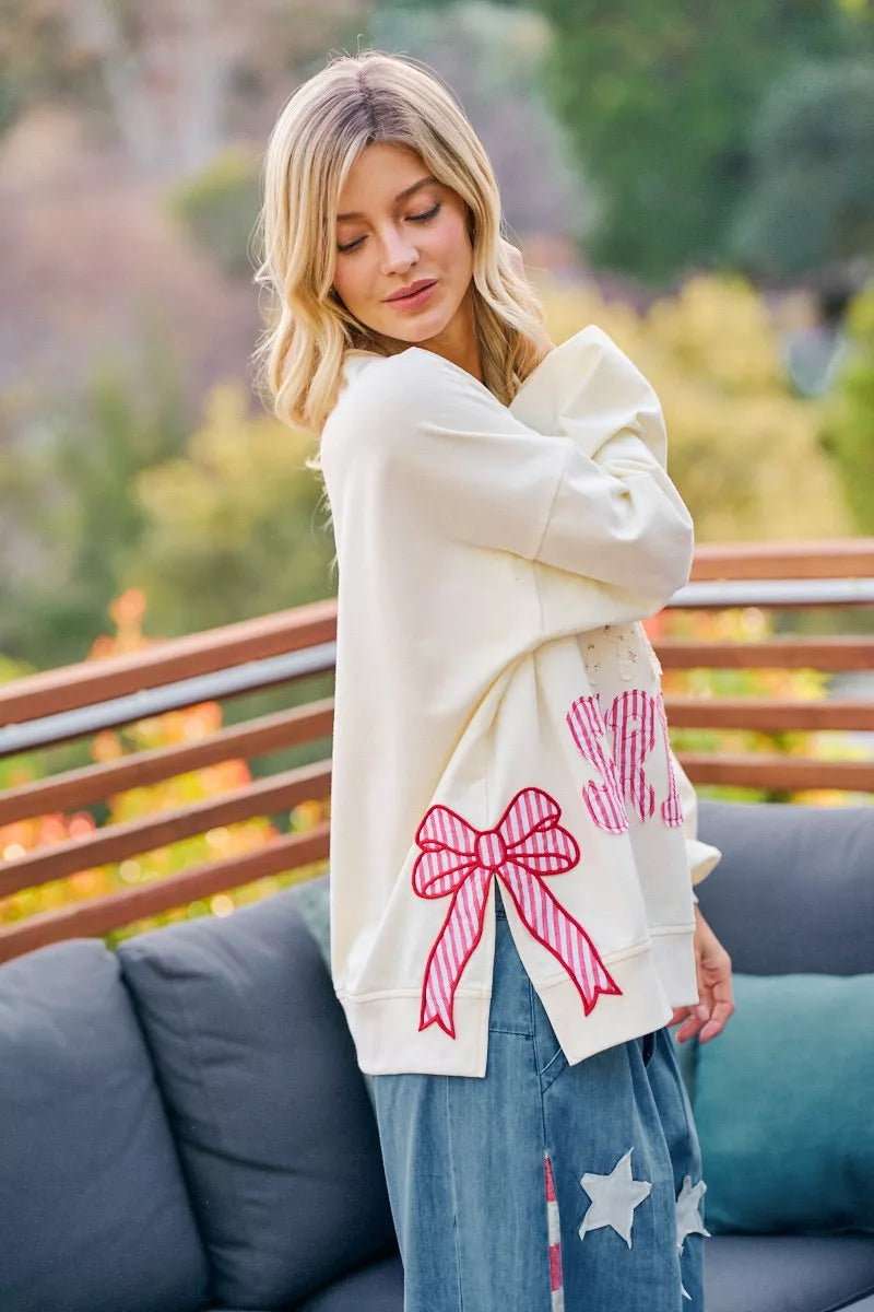 Cream BiBi 4th of July sweatshirt with stars and stripes patches, featuring patriotic red, white, and blue fabric details.