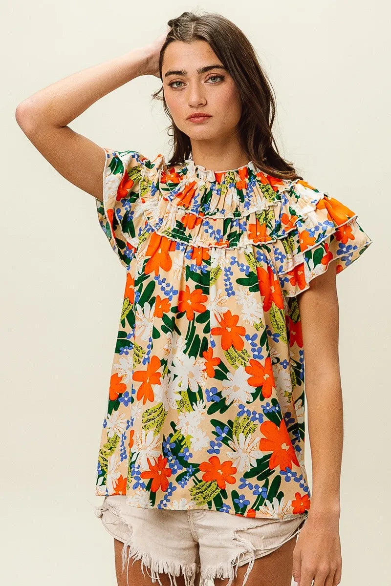 Multi-color floral print woven top by Trendsi featuring cream fabric and vibrant floral pattern, perfect for casual or dressy occasions.