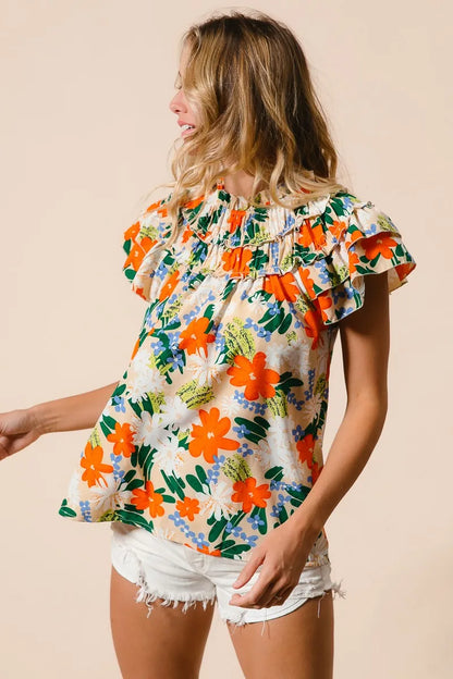 Multi-color floral print woven top by Trendsi, featuring a cream background and stylish design, perfect for casual or trendy outfits.