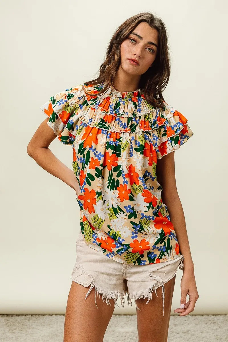 Multi-color floral print woven top by Trendsi featuring cream background and vibrant flower designs.