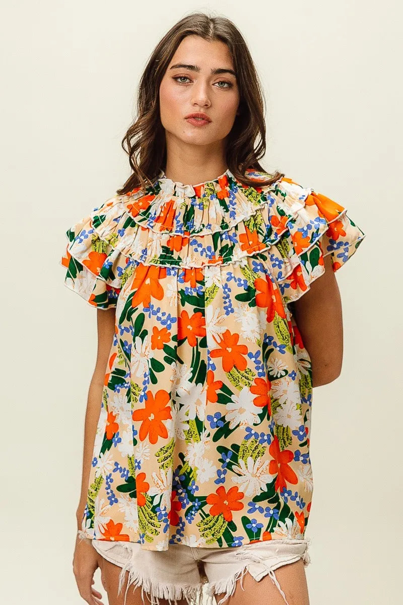 Multi-color floral print woven top by Trendsi, featuring a lightweight design and vibrant floral pattern on cream fabric.