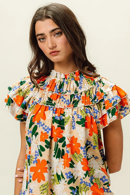 Multi-color floral print woven top by BiBi, featuring a stylish design and vibrant colors, perfect for casual or dressy wear.