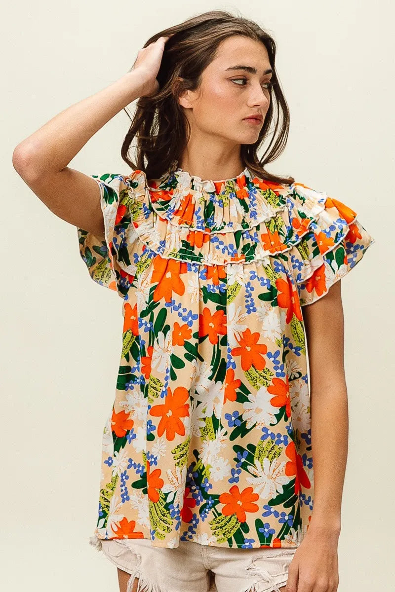 Multi-color floral print woven top by Trendsi, featuring a stylish design with vibrant floral patterns on lightweight fabric.
