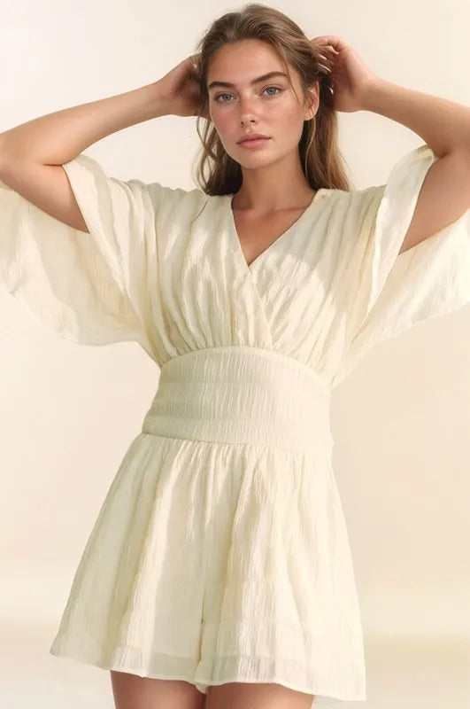 Cream Davi & Dani batwing sleeve waist belt romper with relaxed fit, featured on Trendsi in this stylish, casual women's jumpsuit image.