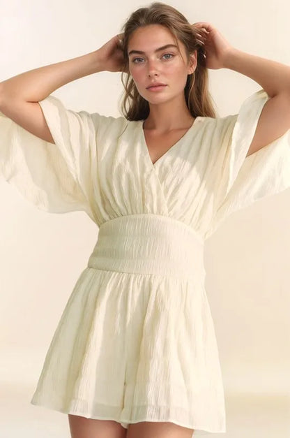 Cream Davi & Dani batwing sleeve waist belt romper with relaxed fit, featured on Trendsi in this stylish, casual women's jumpsuit image.