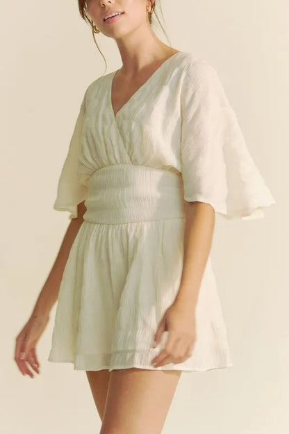 Cream Davi & Dani Batwing Sleeve Waist Belt Romper with relaxed fit and waist belt, stylish and comfortable for casual wear.