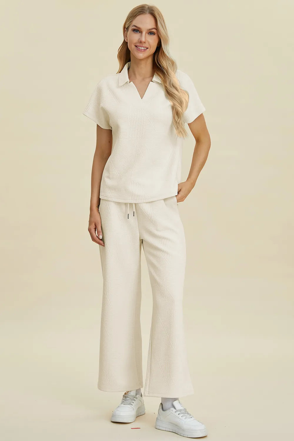 Cream-colored Trendsi double take full-size short sleeve top and pants set with a collared neck, casual and stylish.