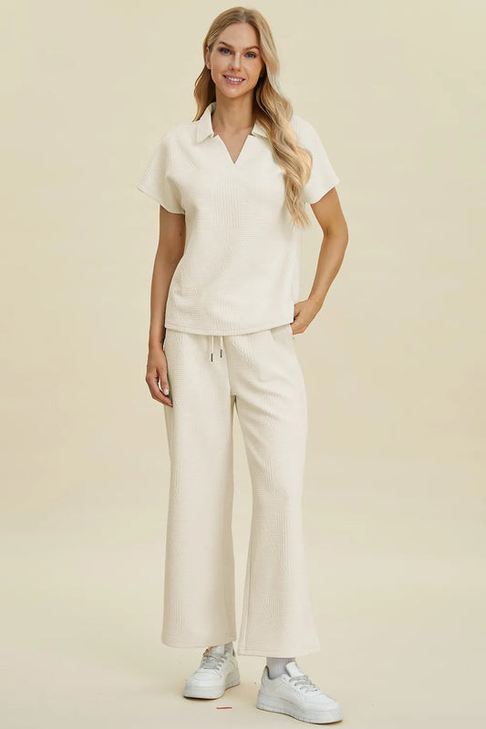 Cream-colored Trendsi double take full-size short sleeve top and pants set with a collared neck, casual and stylish.