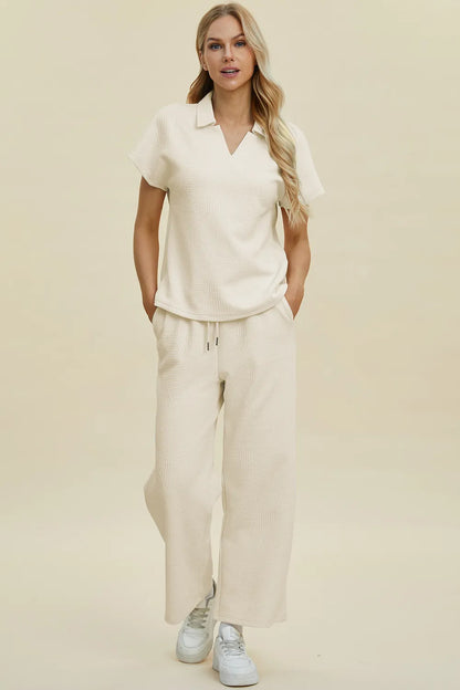 Cream-colored Trendsi Double Take full-size short sleeve top and pants set with a collared neck, casual and stylish for everyday wear.