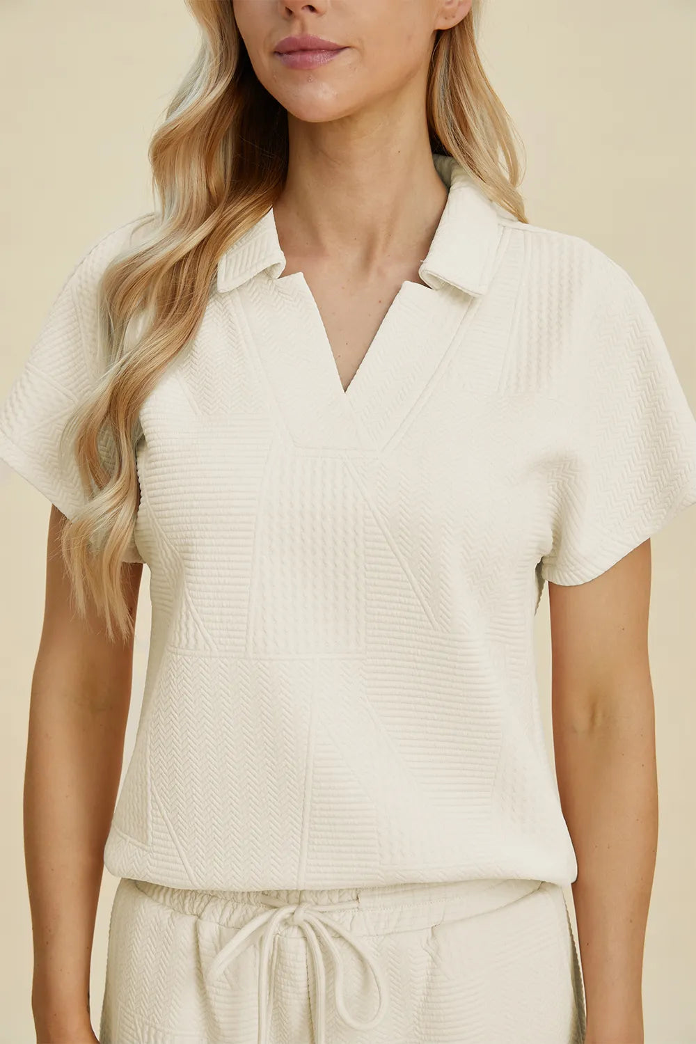 Cream-colored Trendsi Double Take short sleeve top and pants set with a collared neckline, casual and stylish for everyday wear.