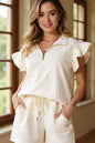 Cream-colored Trendsi Double Take texture flounce sleeve top with matching drawstring shorts set, casual and stylish for everyday wear.
