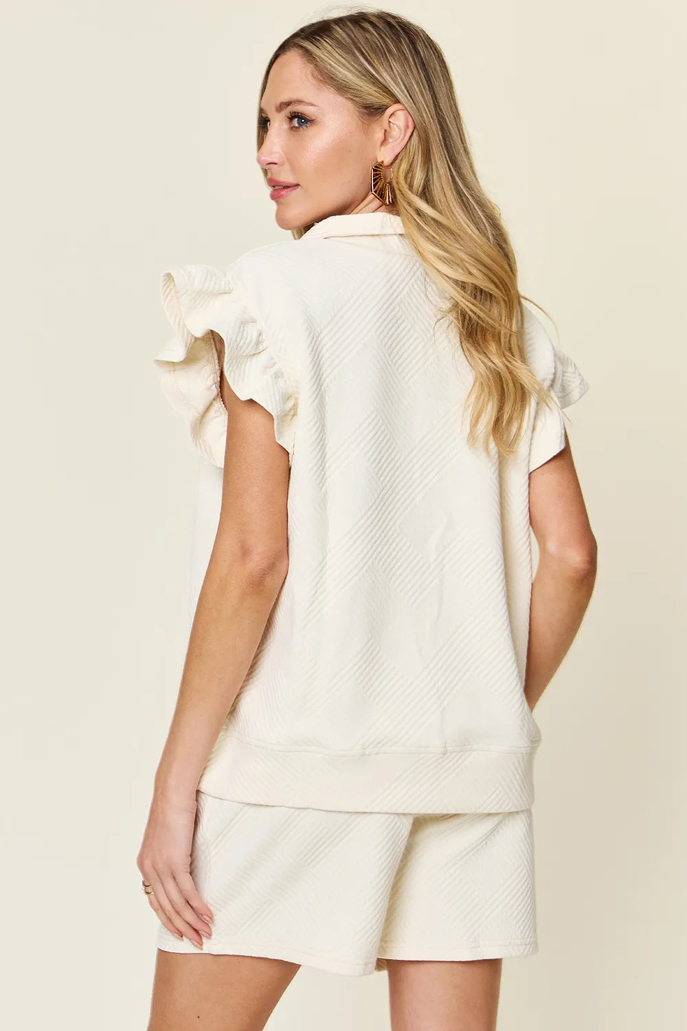 Cream double take texture flounce sleeve top with matching drawstring shorts set by Trendsi, perfect for casual summer wear.