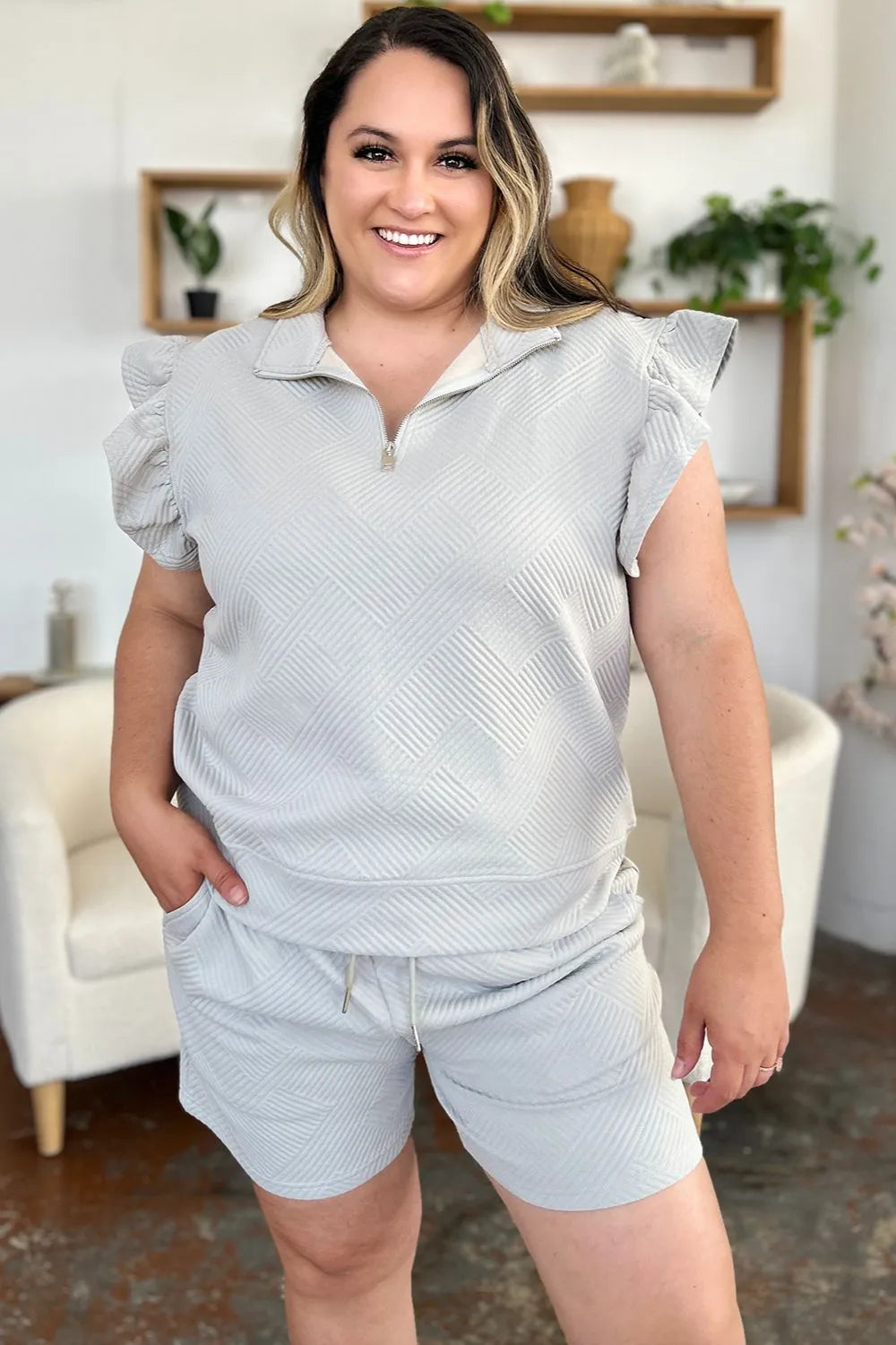 Cream-colored double take texture flounce sleeve top and drawstring shorts set by Trendsi, casual and stylish for warm weather.