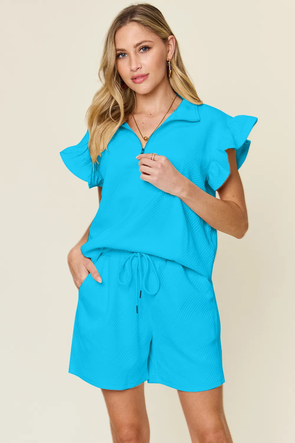 Cream-colored Trendsi double take full-size texture flounce sleeve top with matching drawstring shorts set, casual and stylish.