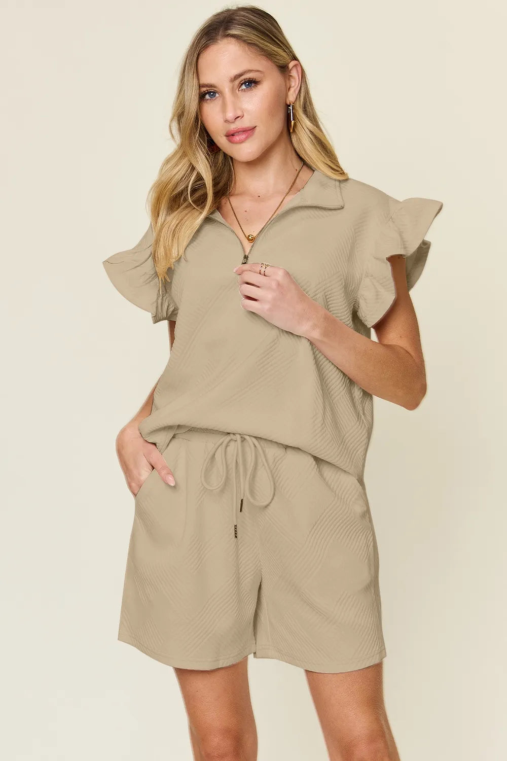 Cream-colored Trendsi double take texture flounce sleeve top with matching drawstring shorts set, casual and stylish for warm days.