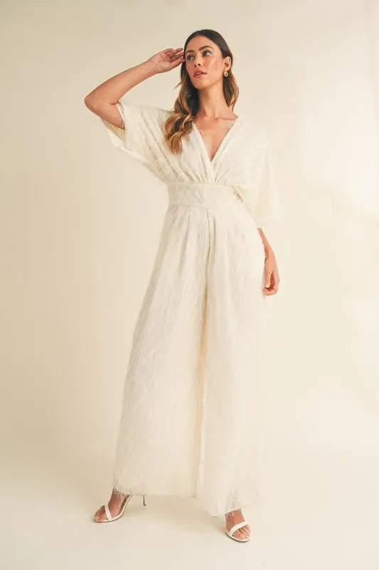 Cream MABLE Fluffy Deep V Neck Wide Leg Jumpsuit by Trendsi, featuring soft fabric and stylish wide-leg design.