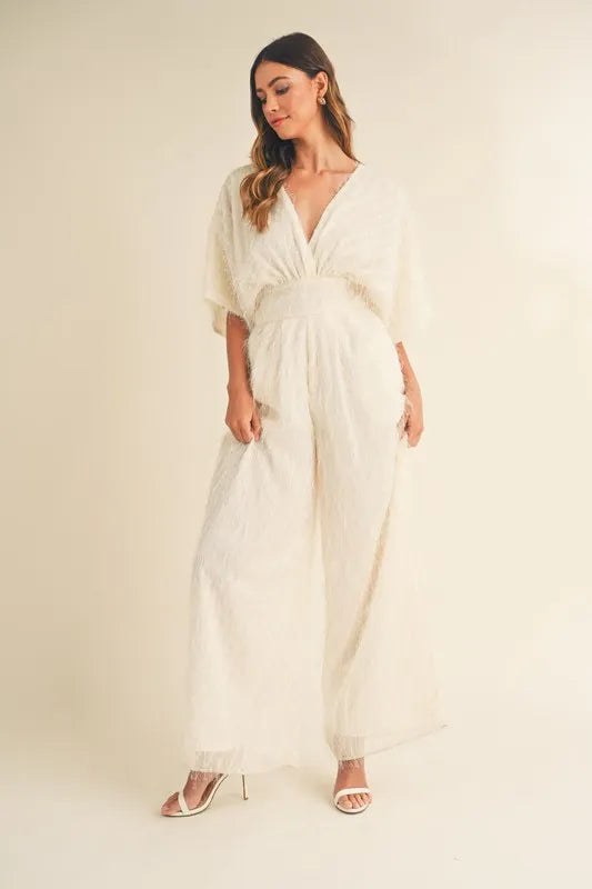 Cream MABLE Fluffy Deep V Neck Wide Leg Jumpsuit by Trendsi, showcasing the soft fabric, deep V neckline, and wide-leg silhouette.