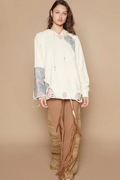 Cream floral patchwork distressed drawstring hoodie from Trendsi, featuring a casual design with floral patterns and distressed details.