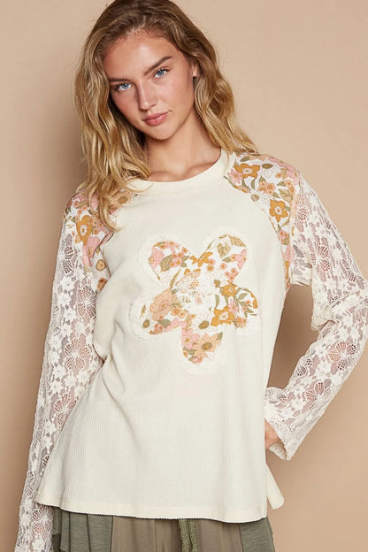 Cream knit top by Trendsi with lace sleeve details and floral patch accents, featuring a stylish and comfortable design.