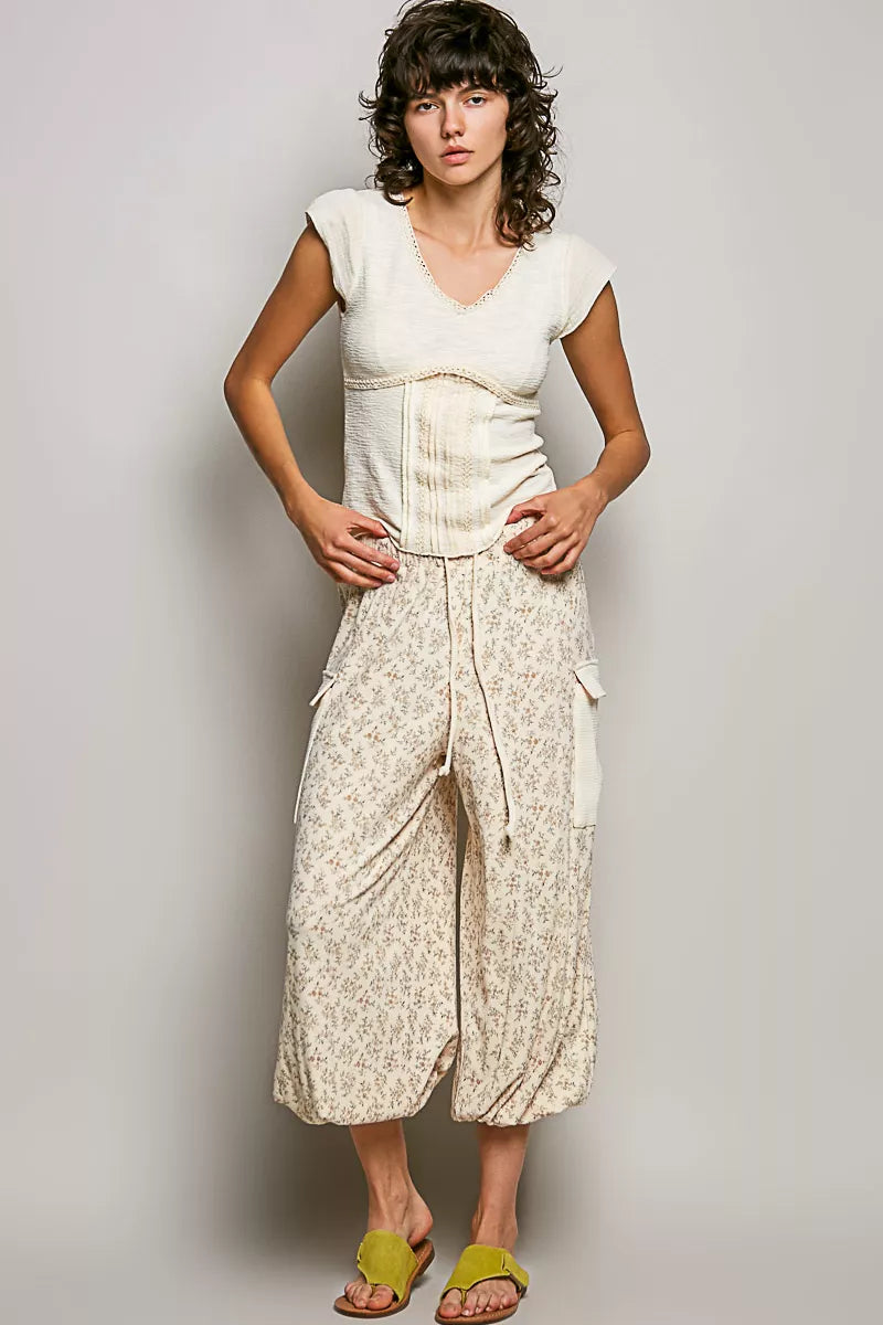 Cream V-neck lightweight textured short sleeve knit top with lace trim, trendy and comfortable by Trendsi.