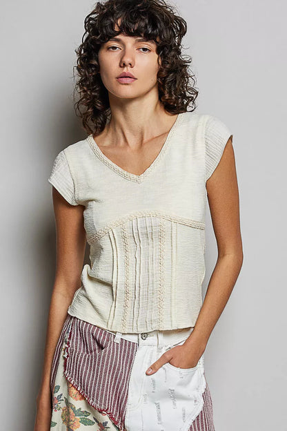 Cream-colored Trendsi V-neck lightweight textured short sleeve knit top with lace trim, showcasing a soft, stylish design.