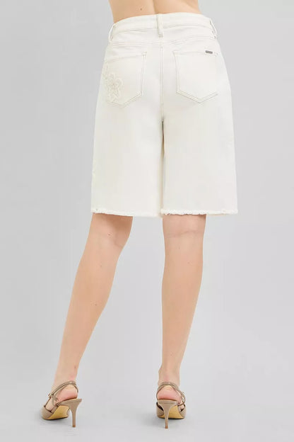 Cream-colored RISEN slouchy relaxed floral embroidered Bermuda denim shorts with distressed details and rolled hems.