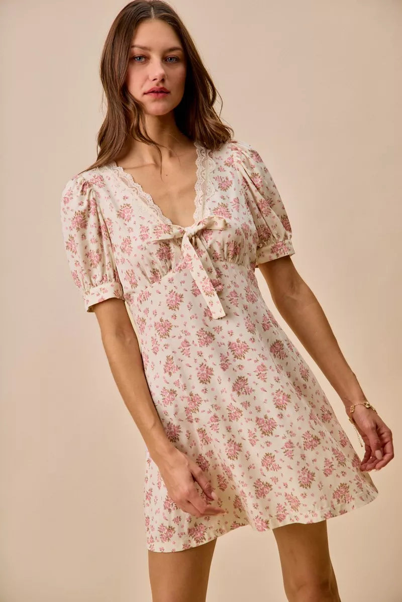 Cream floral lace-trimmed short sleeve mini dress by Trendsi, featuring a stylish fit and elegant lace detailing.