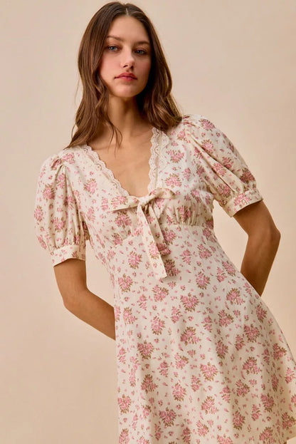 Cream floral lace-trimmed short sleeve mini dress by Trendsi, featuring a fitted silhouette and delicate lace details.