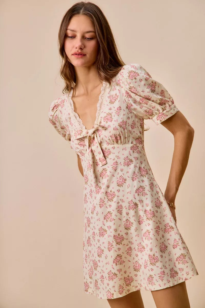 Cream floral lace-trimmed short sleeve mini dress by Trendsi, featuring a feminine design and lightweight fabric.