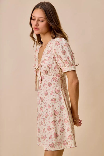 Cream floral lace-trimmed short sleeve mini dress by Trendsi, with a fitted silhouette and delicate lace details.