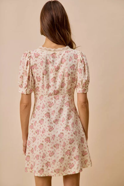 Cream floral lace-trimmed short-sleeve mini dress by Trendsi, featuring a fitted silhouette and delicate lace details.