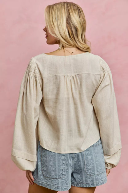 Cream linen blend woven long sleeve top with smocking detail, stylish Trendsi women's blouse with relaxed fit and textured fabric.