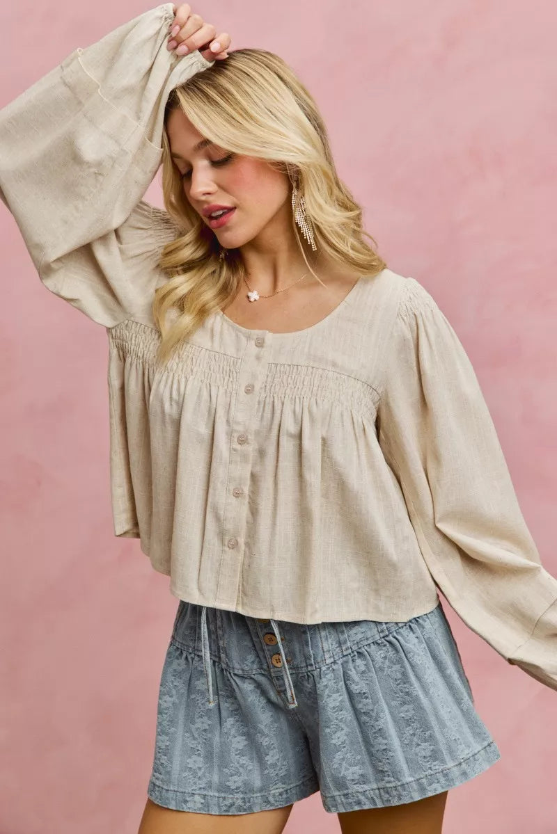 Cream linen blend woven long sleeve top with smocking detail, stylish Trendsi SO ME blouse showing fabric texture and design.