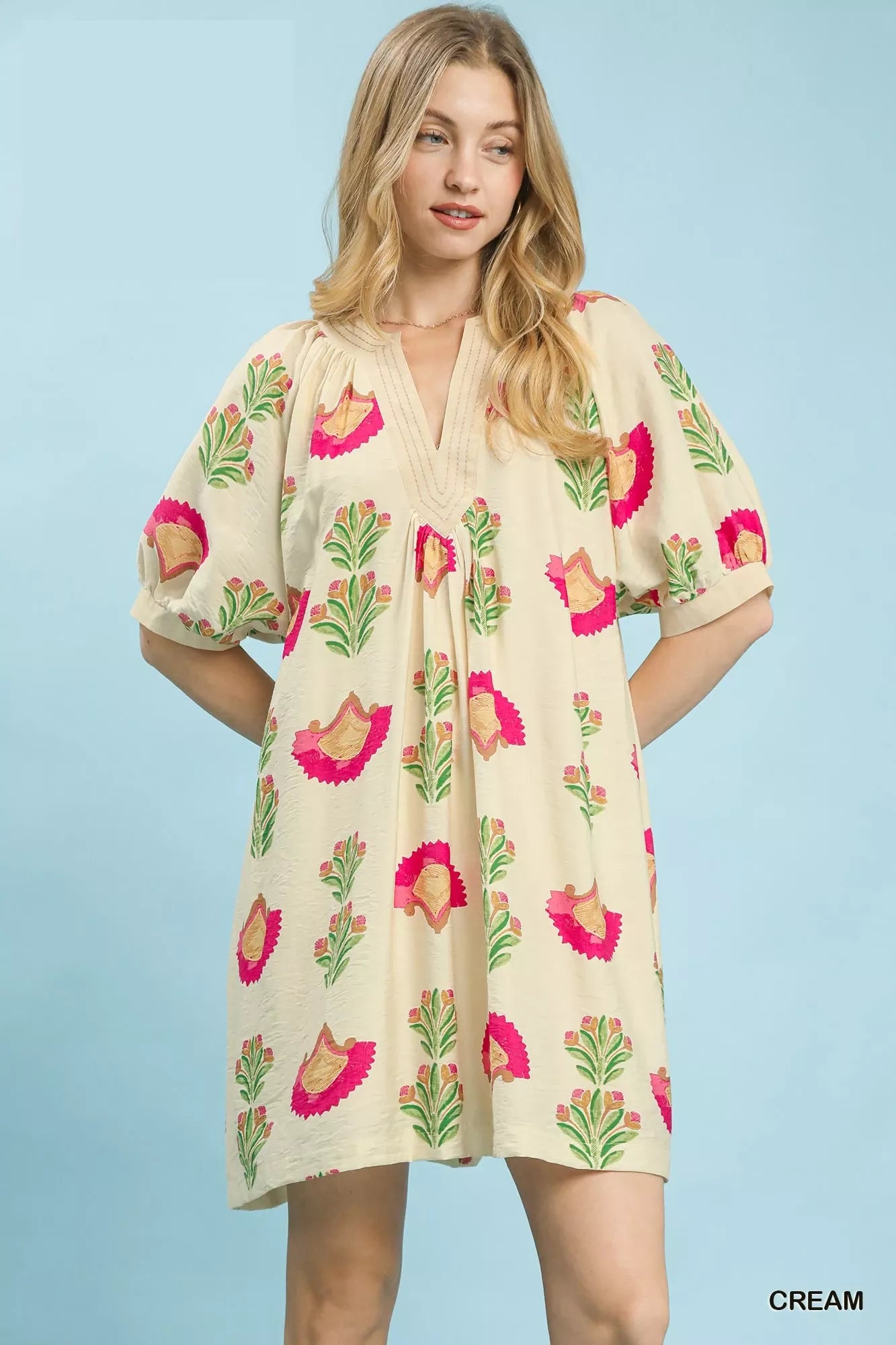 Cream Umgee abstract print mini dress with short sleeves and relaxed fit, featuring a stylish, artistic pattern.