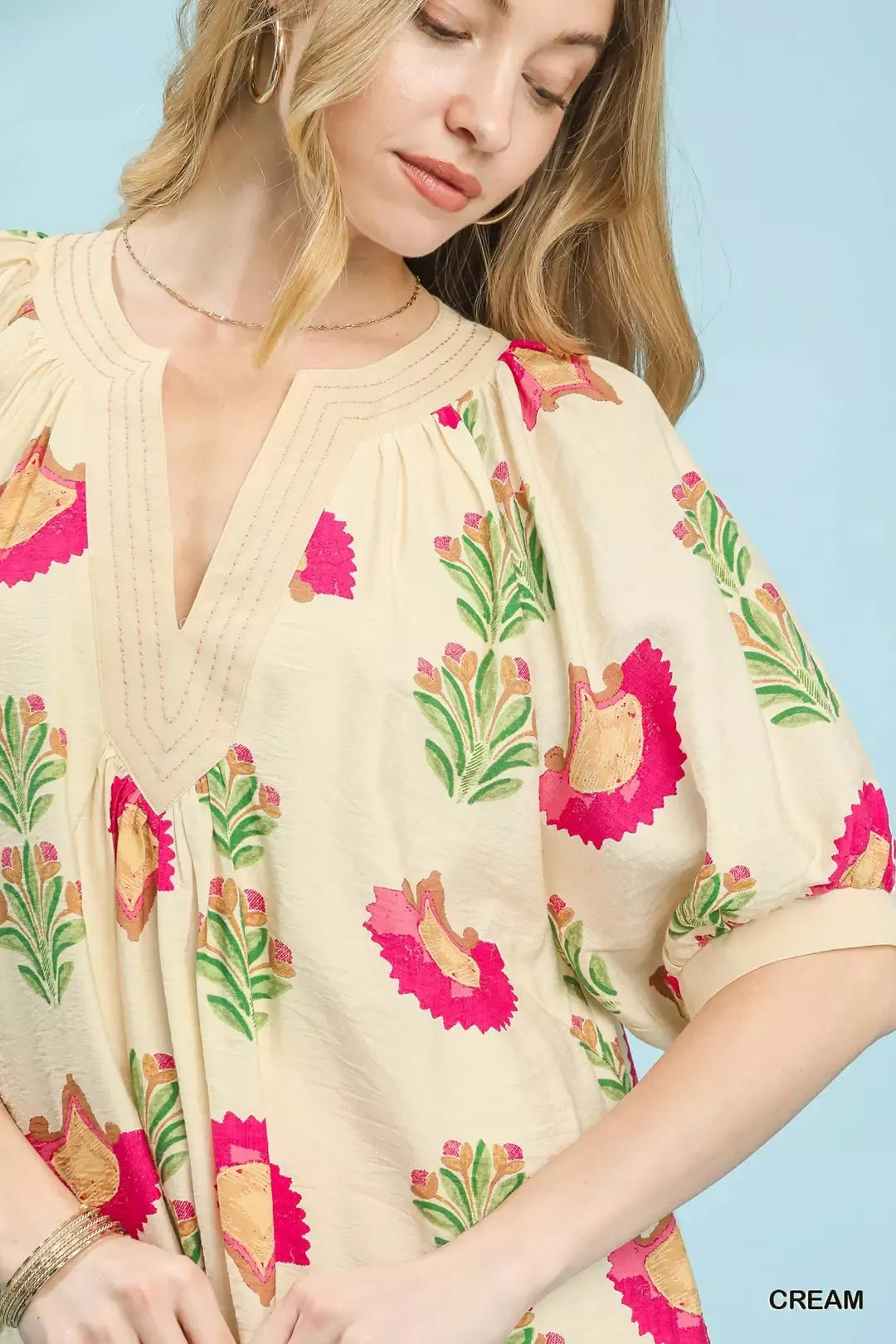 Cream Umgee abstract print mini dress with long sleeves and relaxed fit, perfect for casual or chic summer outfits.